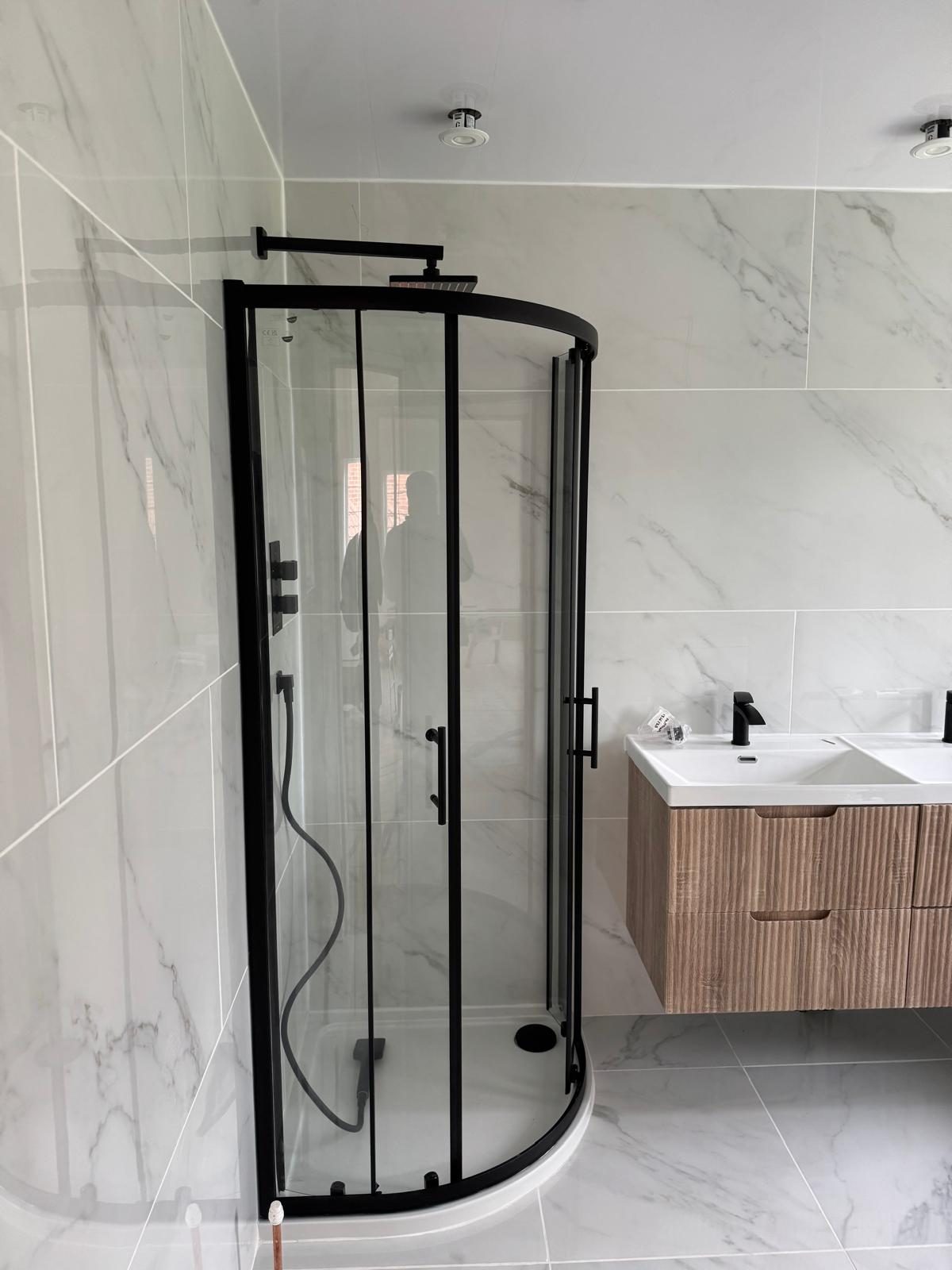 Completed marble-tiled bathroom renovation by Plummer's Home Improvements