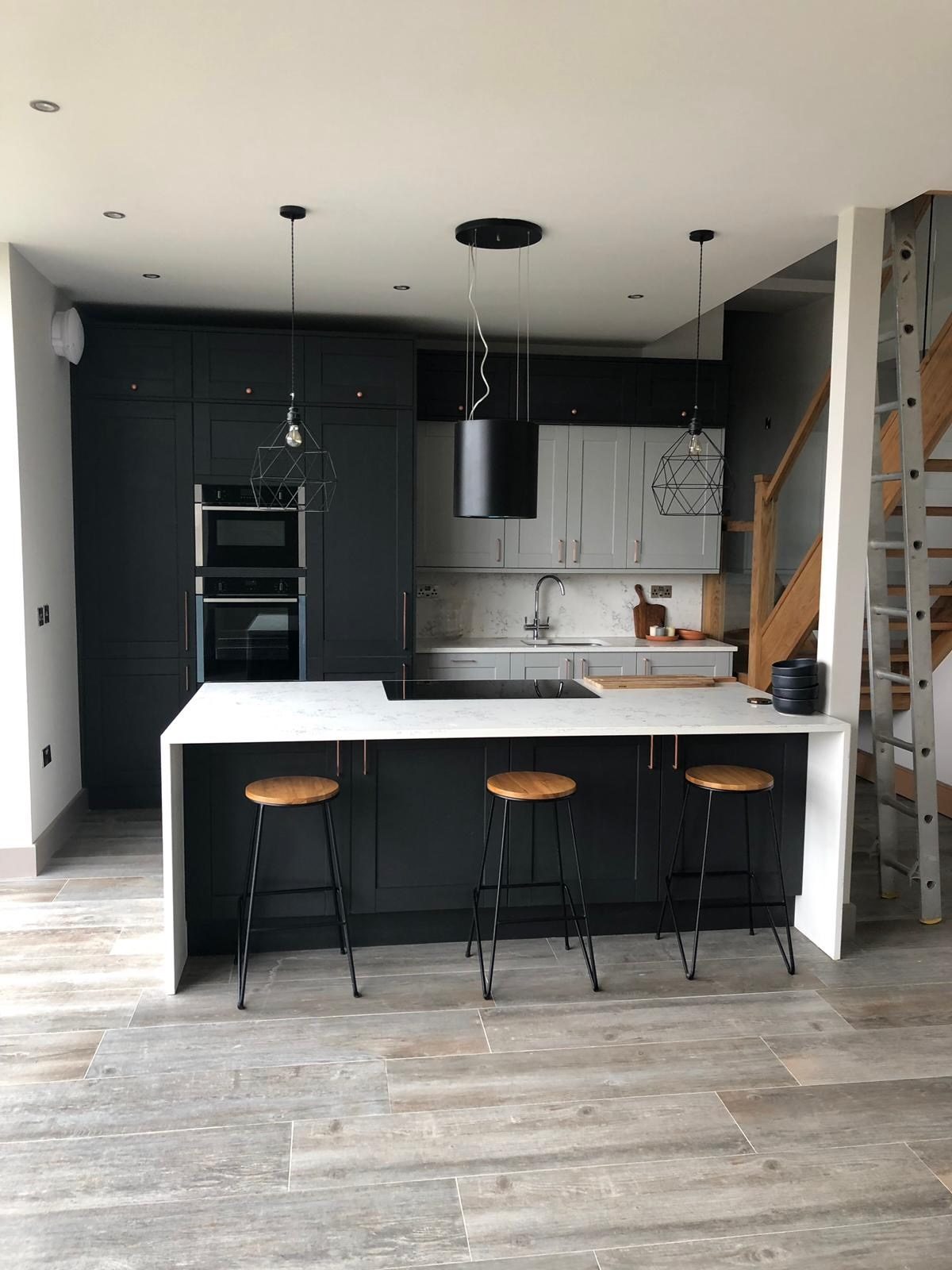 Fitted kitchen with a central island and breakfast bar