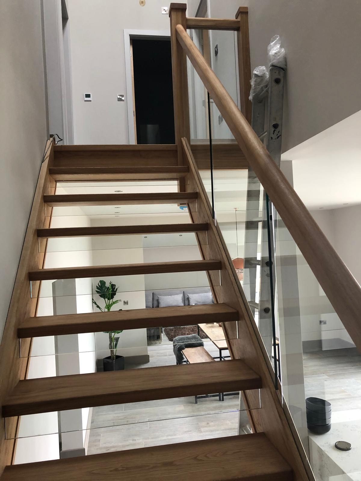 Oak and glass staircase fitted during a full home renovation